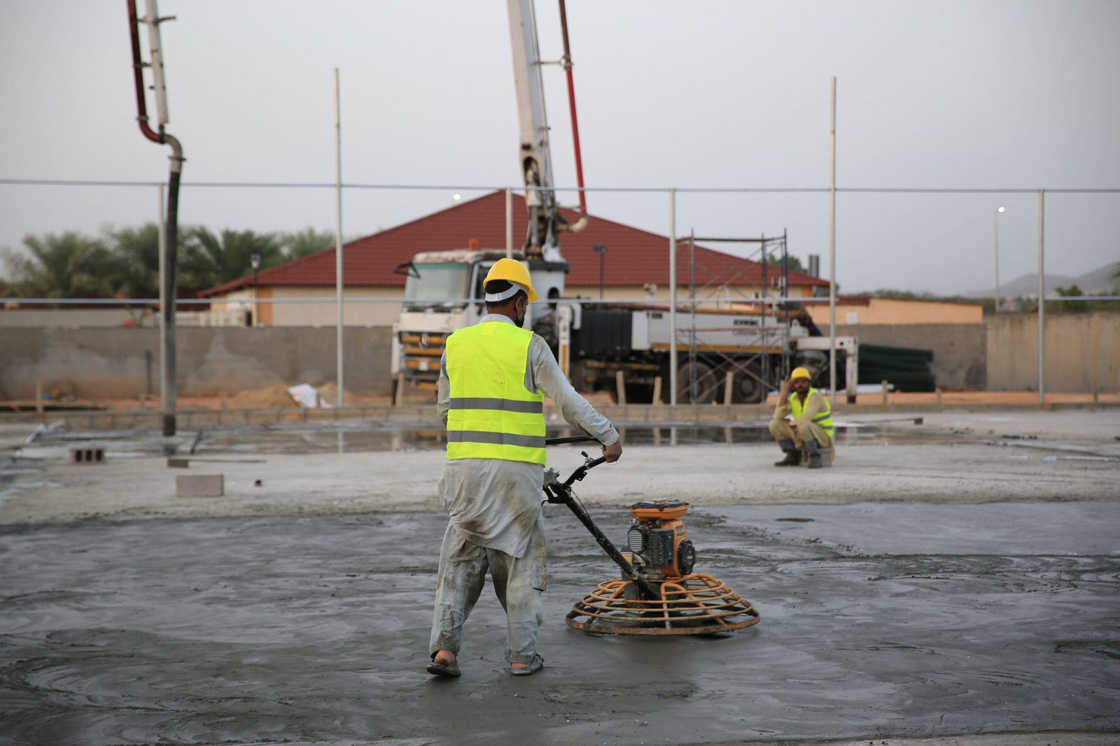 Concrete slab being power-troweled smooth, an example of the flatwork we pour